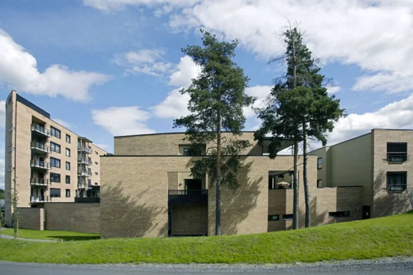 rolvsrudhjemmet, sykehjem og omsorgsboliger. Fasade i lys brun tegl og detaljer i varierte farger.